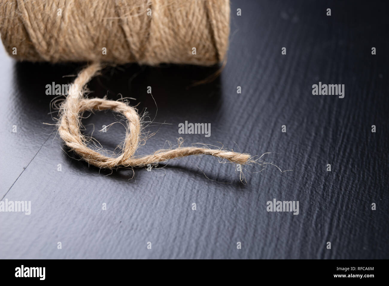 Twine for wrapping packages on the table. Jute string wrapped around