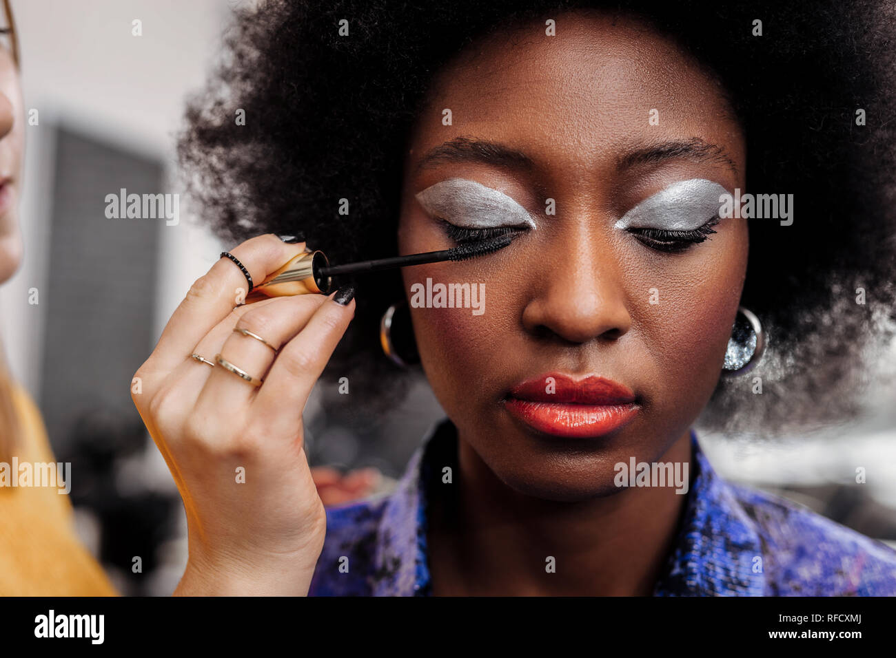 Dark-haired beautiful model with bright lips looking down Stock Photo