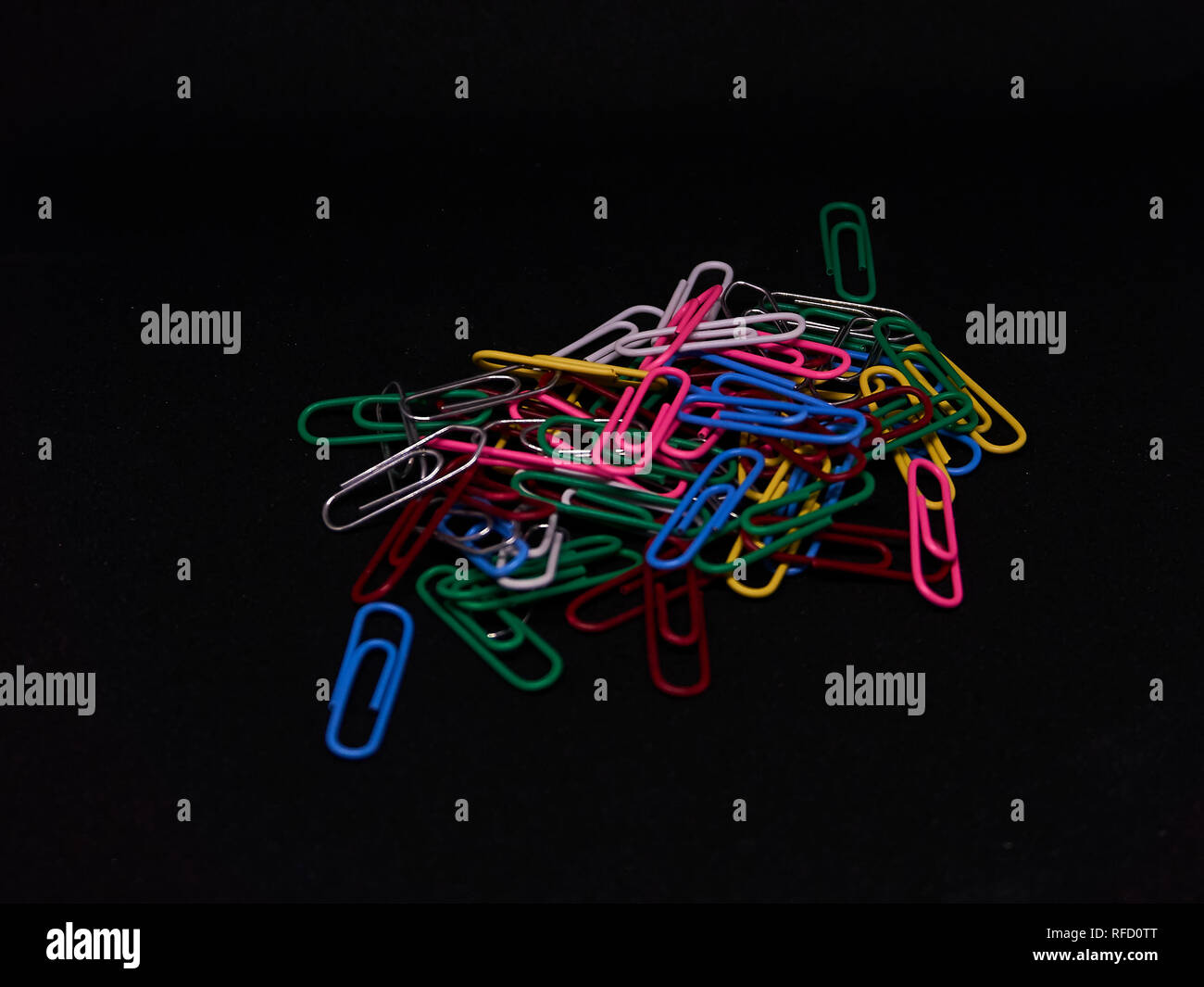 colourfull paperclips with a black background Stock Photo