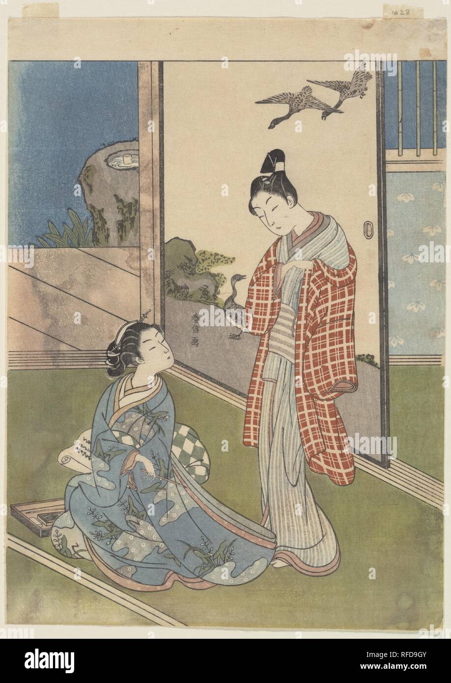 A Girl Writing a Letter. Artist: Suzuki Harunobu (Japanese, 1725-1770). Culture: Japan. Dimensions: H. 11 1/2 in. (29.2 cm); W. 8 1/4 in. (21 cm). Date: 18th century.  The seated young woman has been writing what is probably a love letter, but she attempts to hide it from the man who has just entered. The painting on the sliding screen behind the figures provides Harunobu with the opportunity to elaborate on the theme of letter writing by alluding to a classical episode from ancient Chinese history. Su Wu (J.: Sobu), a Chinese general of the Han period (206 B.C.-A.D. 220), was captured by inva Stock Photo