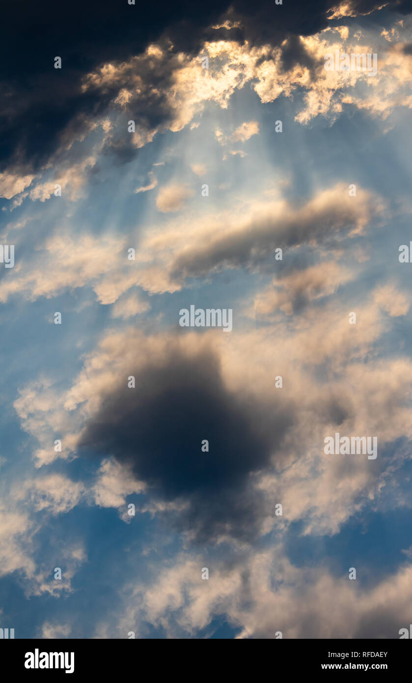The sun shines through the clouds Stock Photo