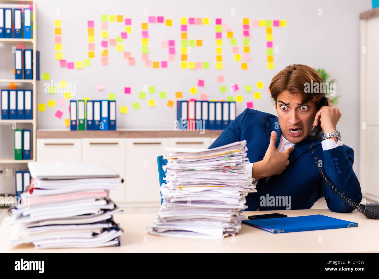 Young employee suffering from excessive work Stock Photo