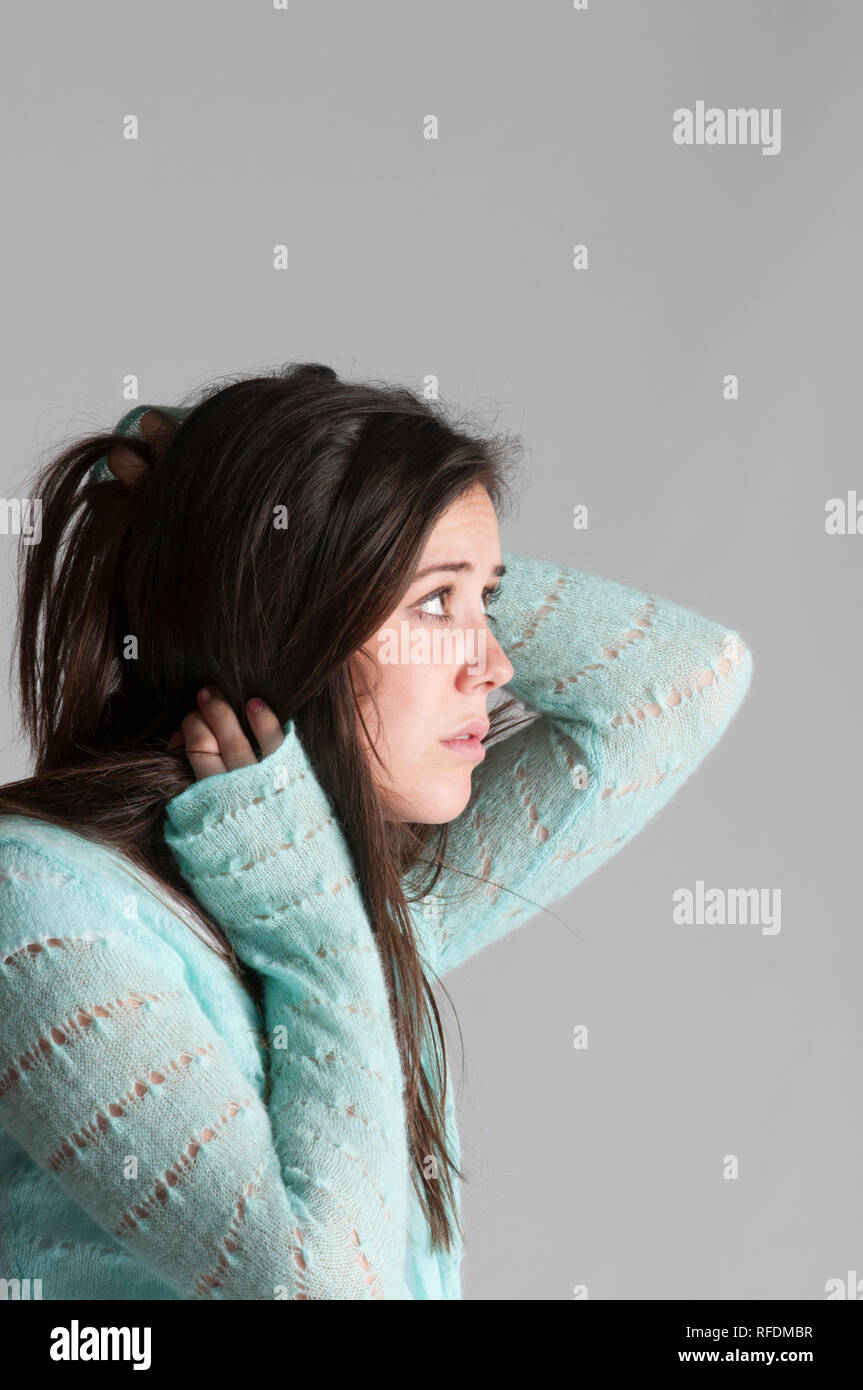 Side view of scared young woman looking away Stock Photo - Alamy