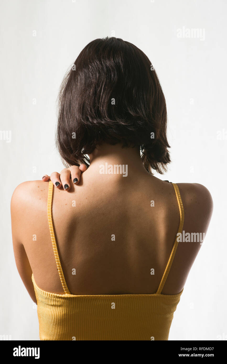 Rear view of a woman hand touching back Stock Photo - Alamy
