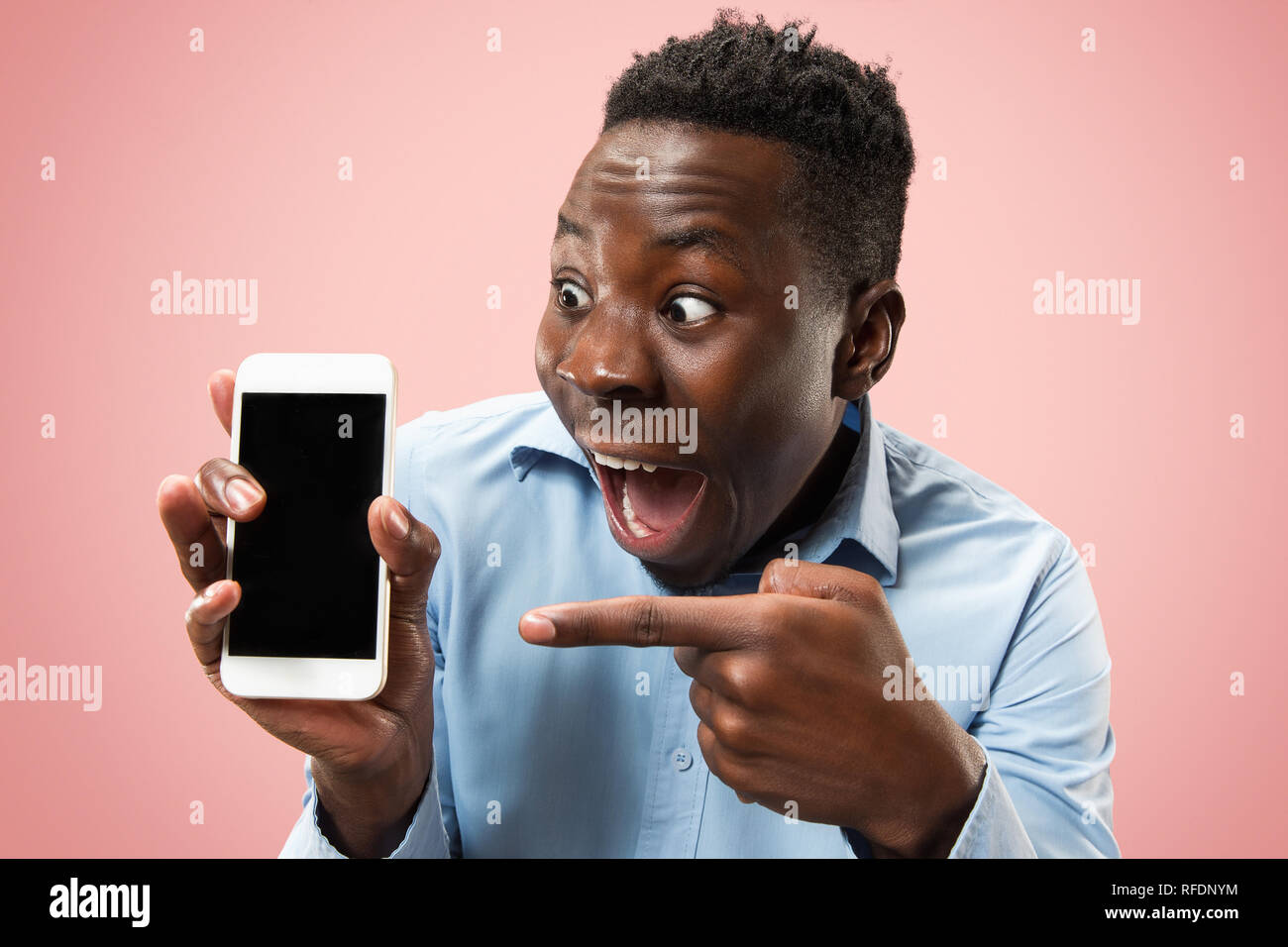Indoor portrait of attractive young black african man isolated on pink ...