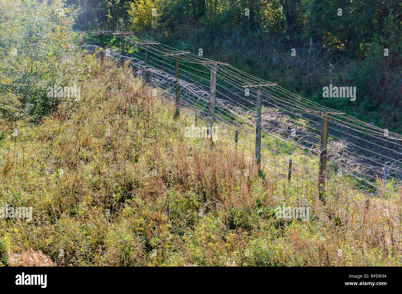 fencing territory with barbed wire, barbed wire fence Stock Photo