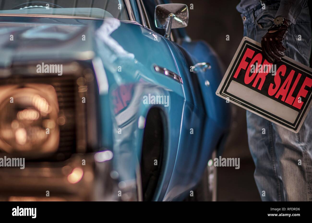 Men Putting His Classic Car Up For Sale Keeping For Sale Sign in a Hand