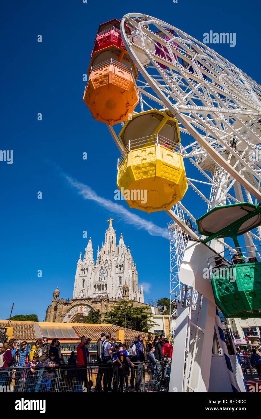 Amusement park in front of Temple Expiatori del Sagrat Cor, Temple of the Sacred Heart of Jesus in Tibidabo Stock Photo