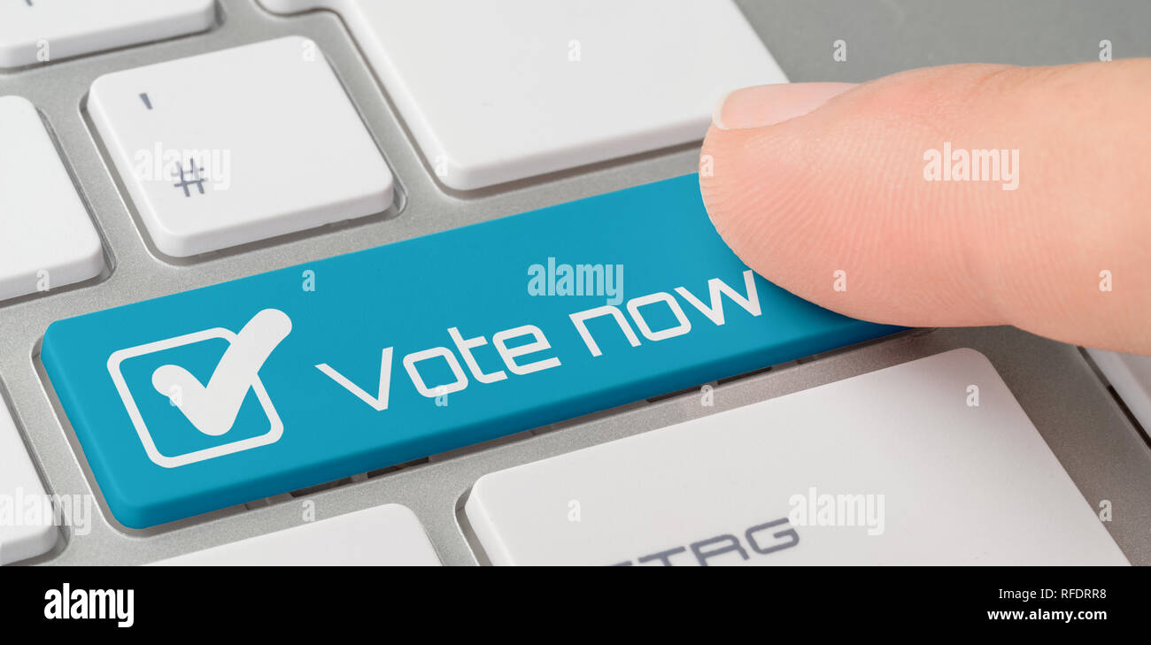 A keyboard with a blue labeled button - Vote now Stock Photo - Alamy