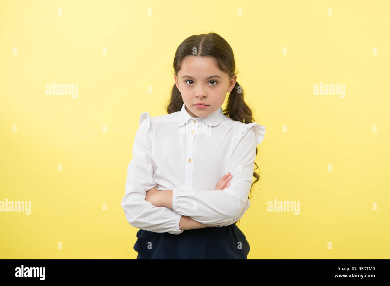 confident schoolgirl. confident and carefree schoolgirl. small schoolgirl  with confident look. confident schoolgirl on yellow background Stock Photo  - Alamy