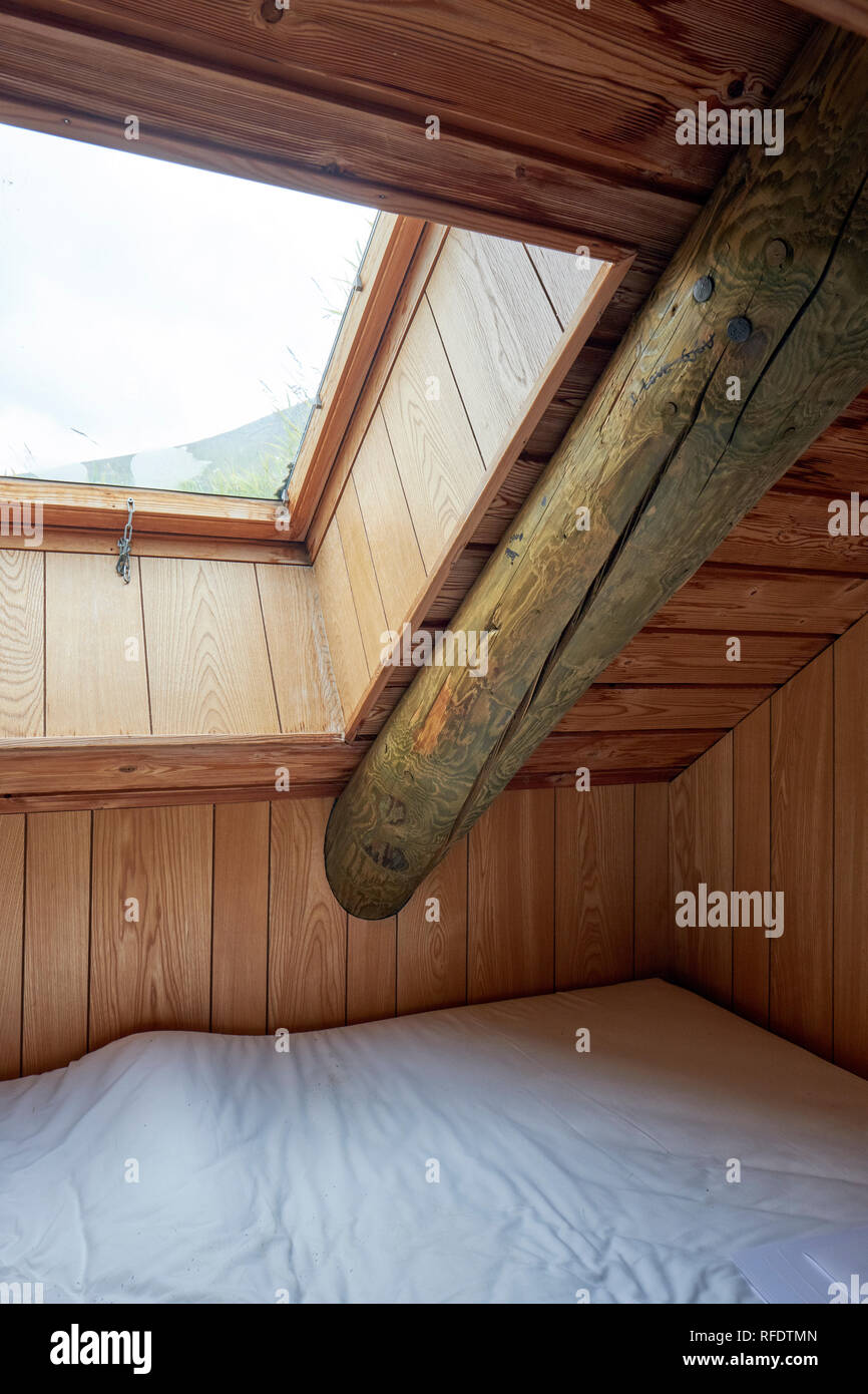 A well insulated roof / loft bed with skylight window and woodwork in a Faroese guesthouse. Stock Photo