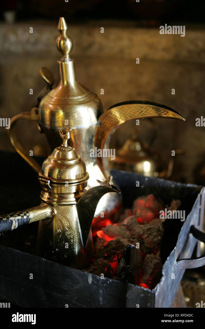Making of traditional arabian coffee with cardamom, Qahwa masbuta