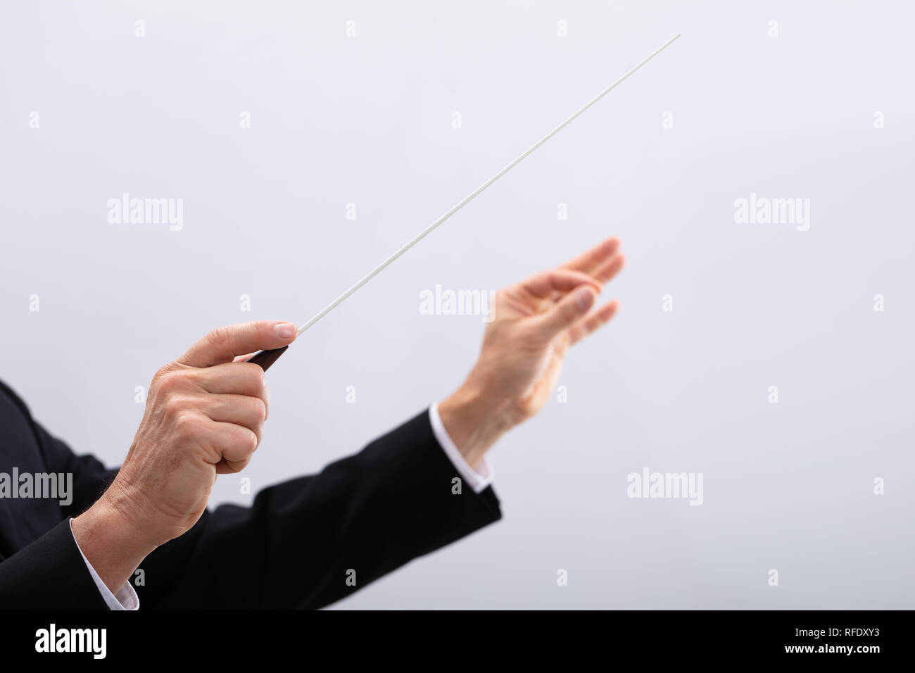 Close-up Of A Person's Hand Directing With Conductors Baton Stock Photo