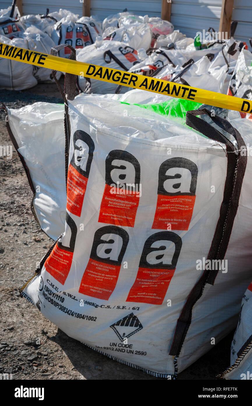 Asbestos removal site. Special bags for the transport of asbestos materials  waiting on a secure storage area Stock Photo - Alamy
