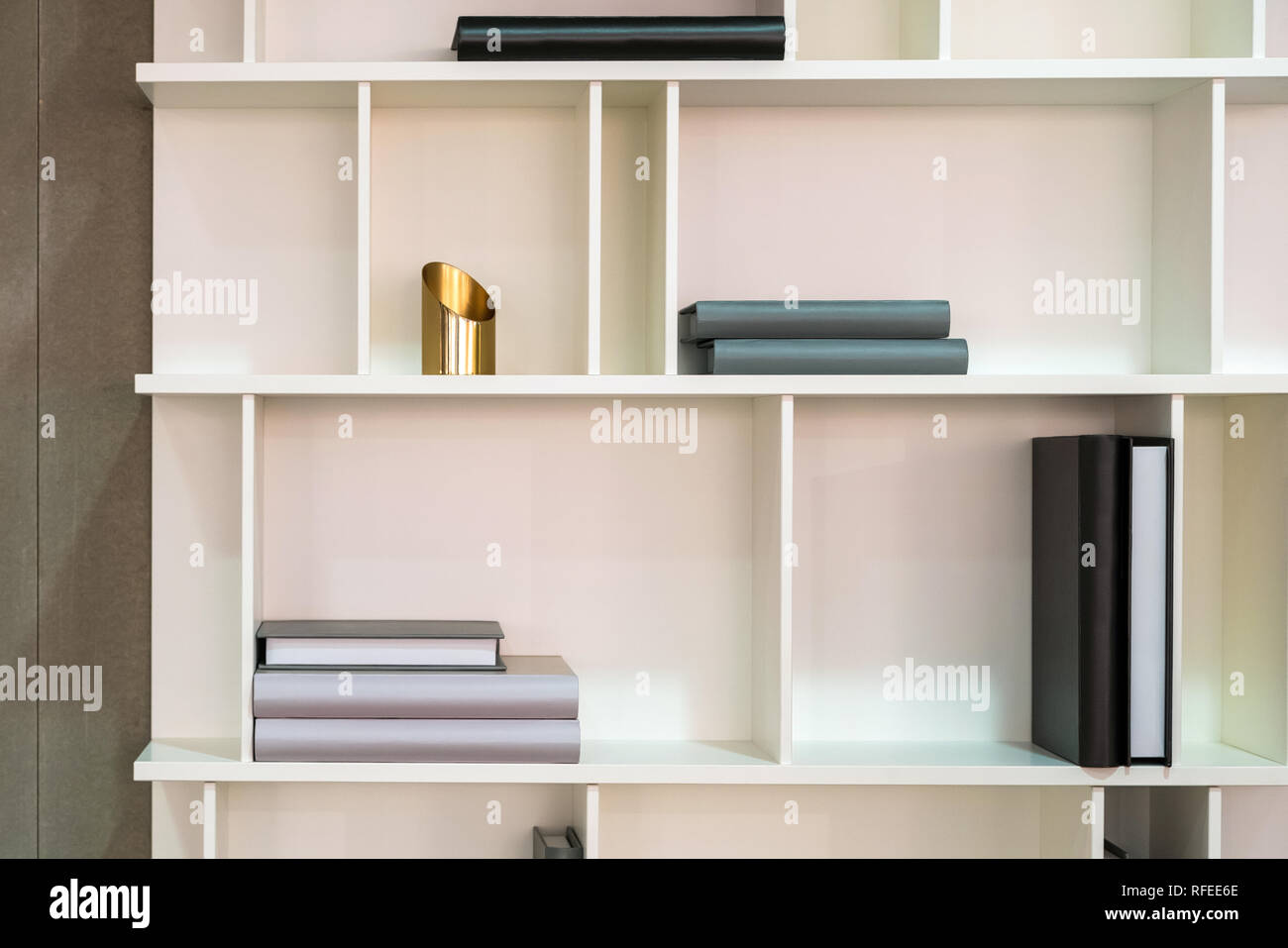 White wooden shelf indoor with different home related objects. Books