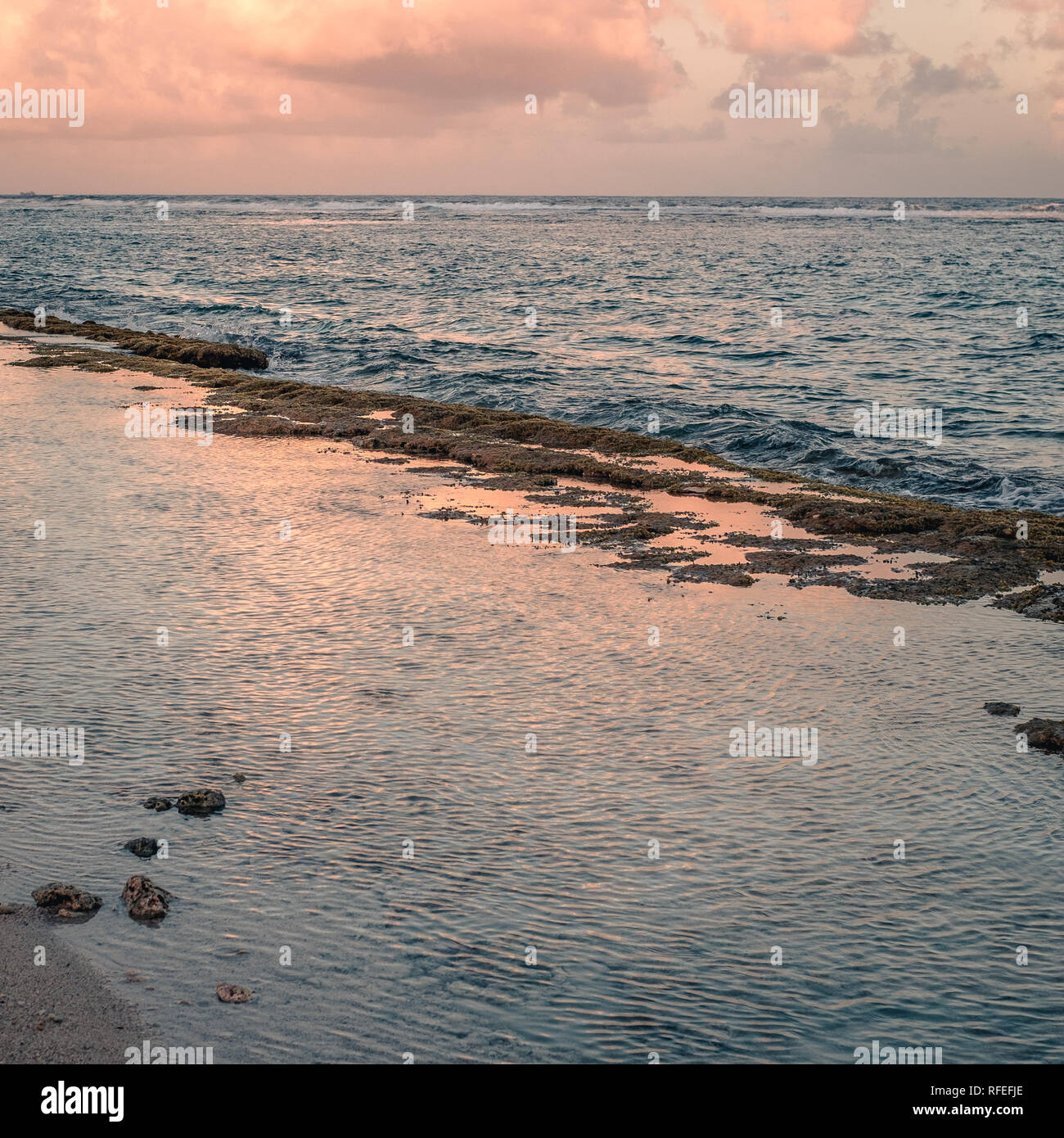 sea reflecting light from the clouds at sunset time. San Andrés island, Colombia. Stock Photo