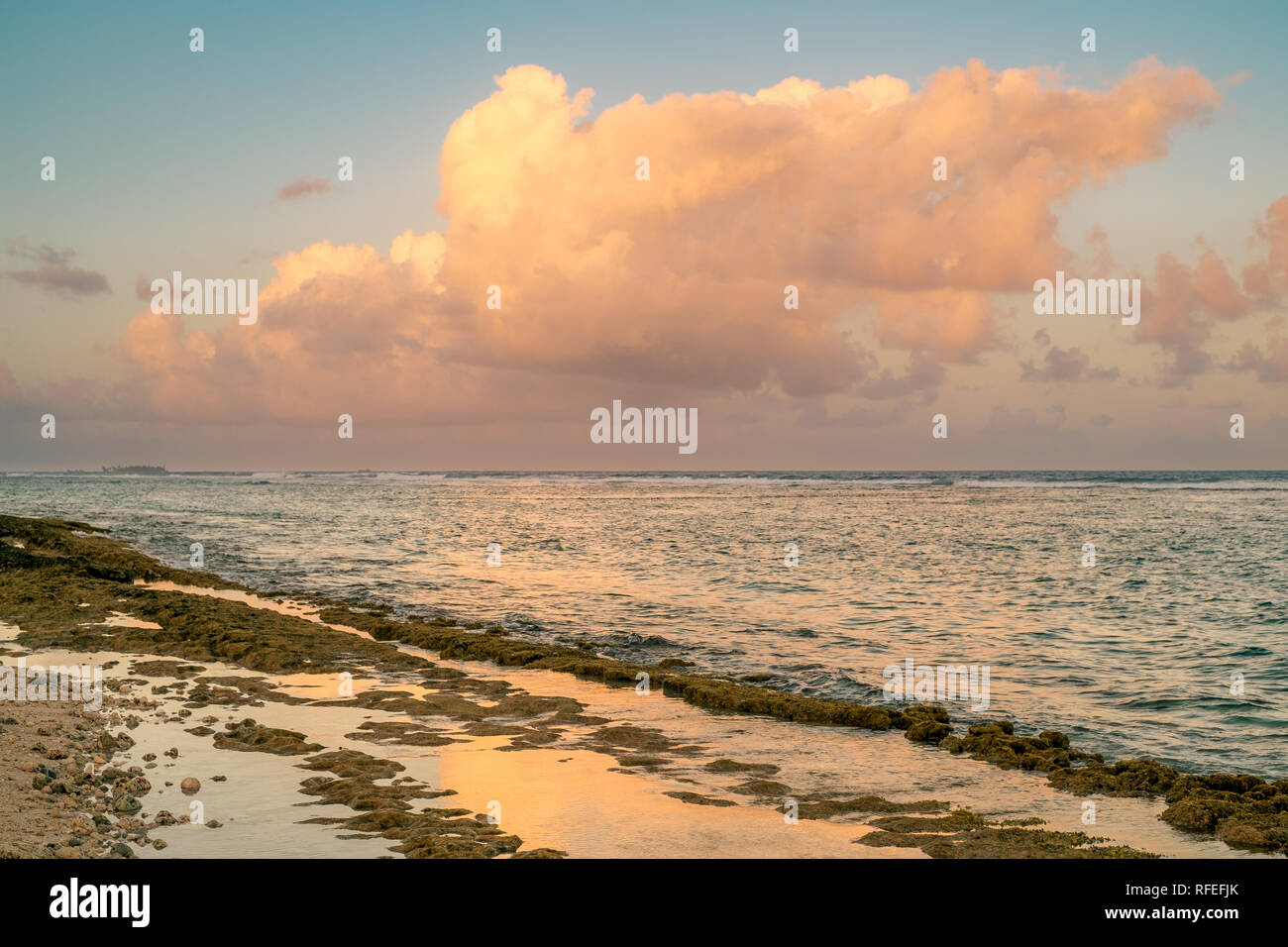 The shoreline reflect clouds at sunset time. San Andrés island, Colombia. Stock Photo