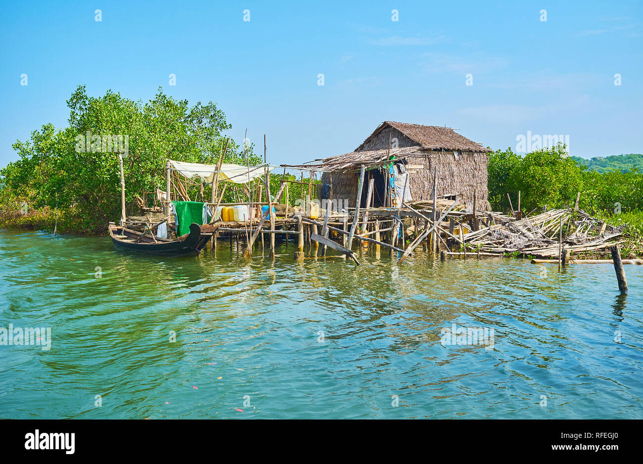 The small fishing village with wooden and straw huts among the mangrove forests on Kangy river