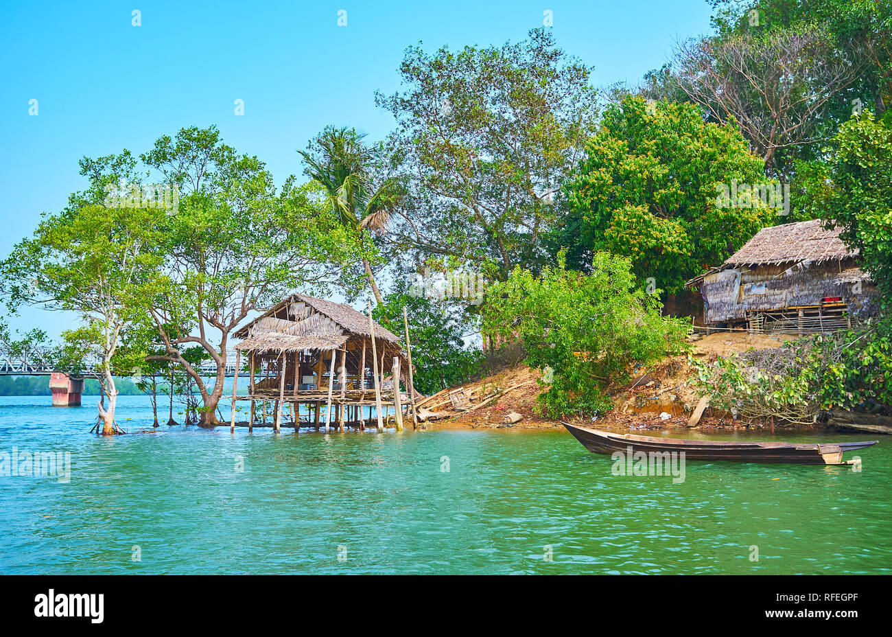 The old nipa hut of the local fishermen at the green bank of Kangy river, Chaung Tha zone, Myanmar. Stock Photo