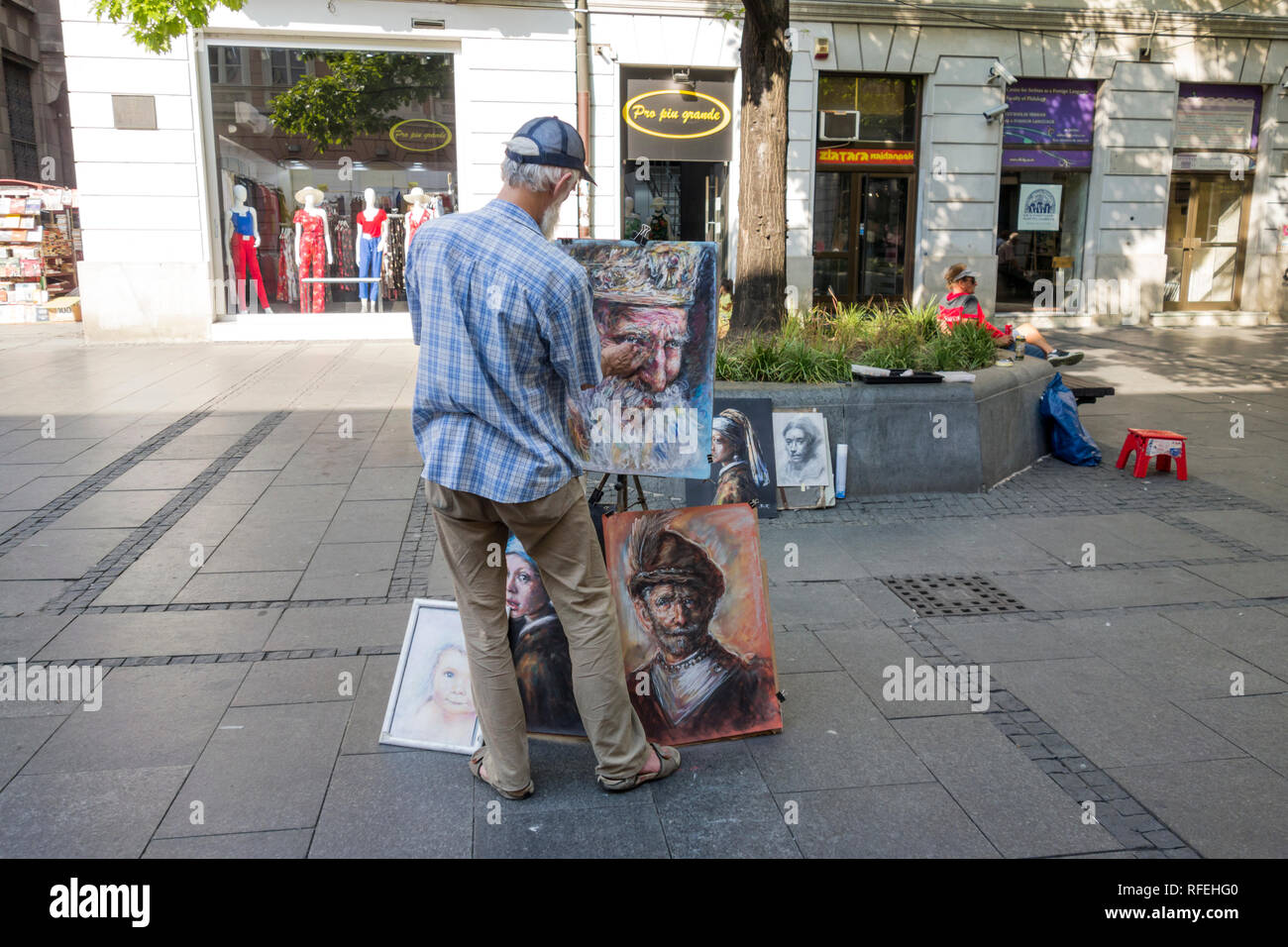 Street painter draws and sells his paintings in Knez Mihailova Street in Belgrade, Serbia Stock Photo
