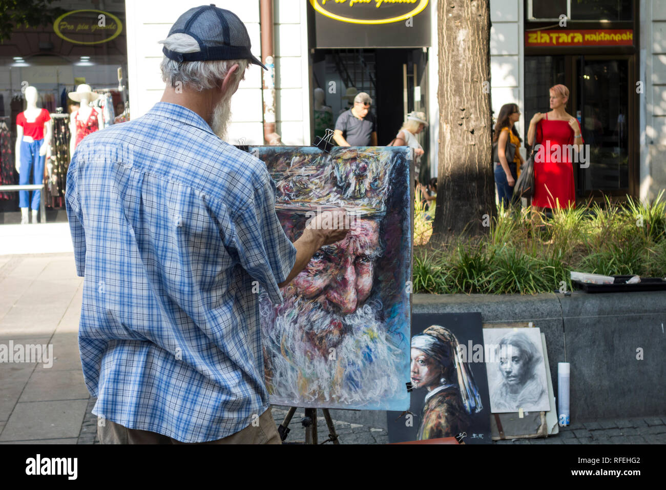 Street painter draws and sells his paintings in Knez Mihailova Street in Belgrade, Serbia Stock Photo