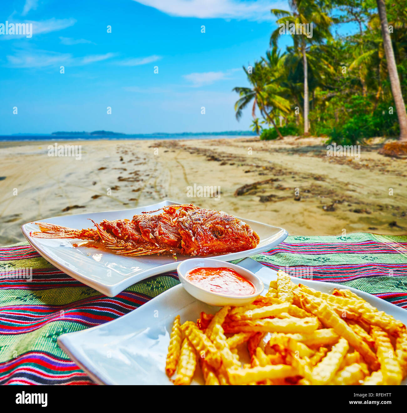 Enjoy the picnic on the secret beach with deep fried fish and French fries with sauce, Chaung Tha, Myanmar. Stock Photo