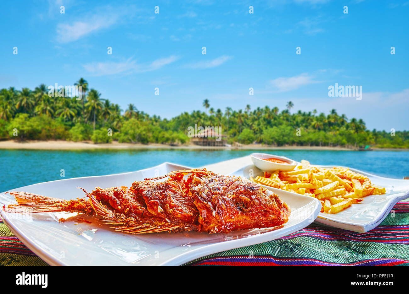 Chaung Tha resort boasts numerous cafes and restaurants, offering best local dishes, such as deep fried fish with spices, herbs, different sauces and  Stock Photo