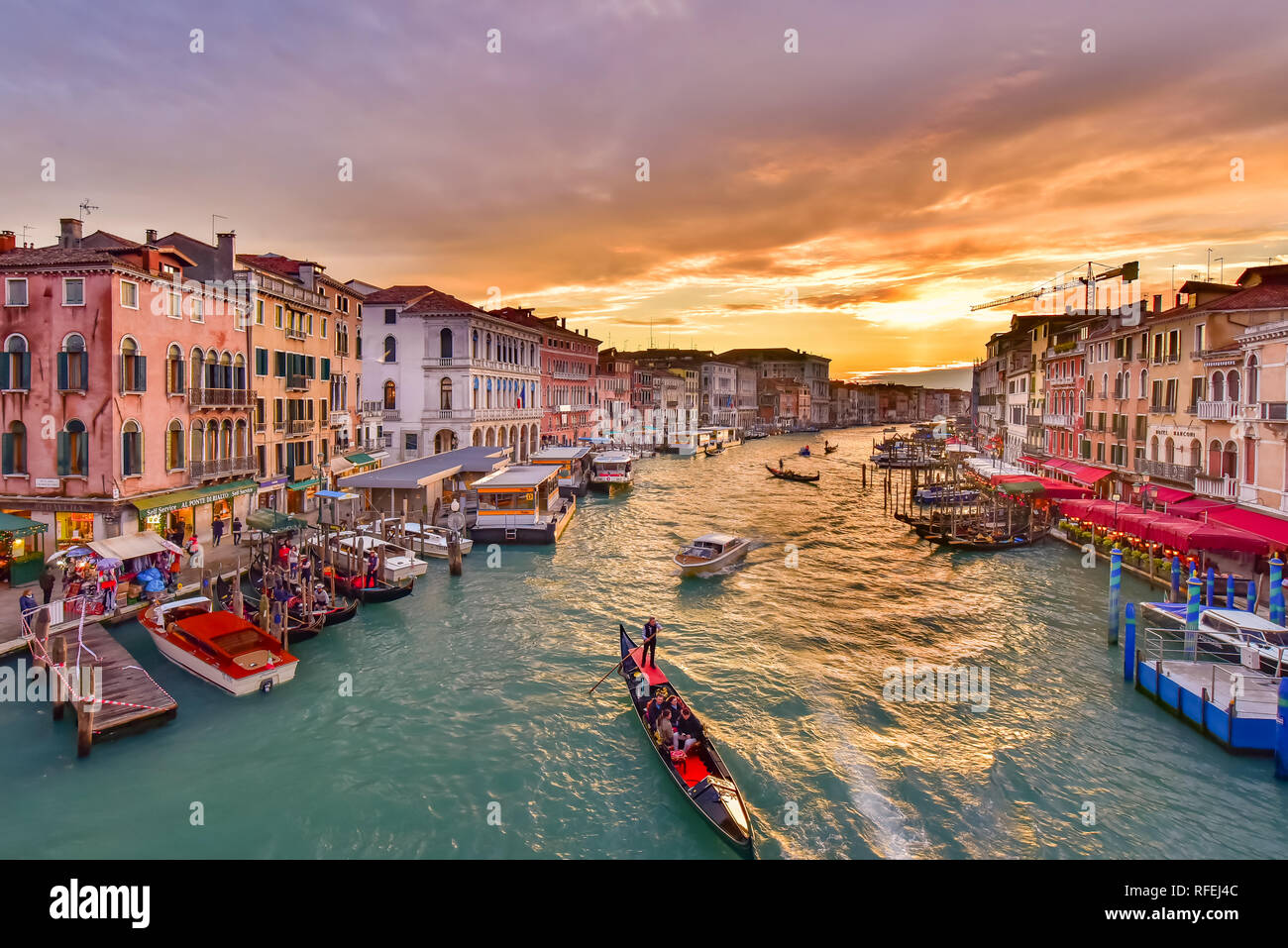 The Grand Canal with gondola and vaporetto at sunset time, Venice, Italy Stock Photo