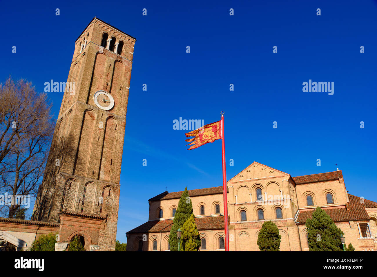 Clock tower and flag of Venice, Lion of Saint Mark Stock Photo