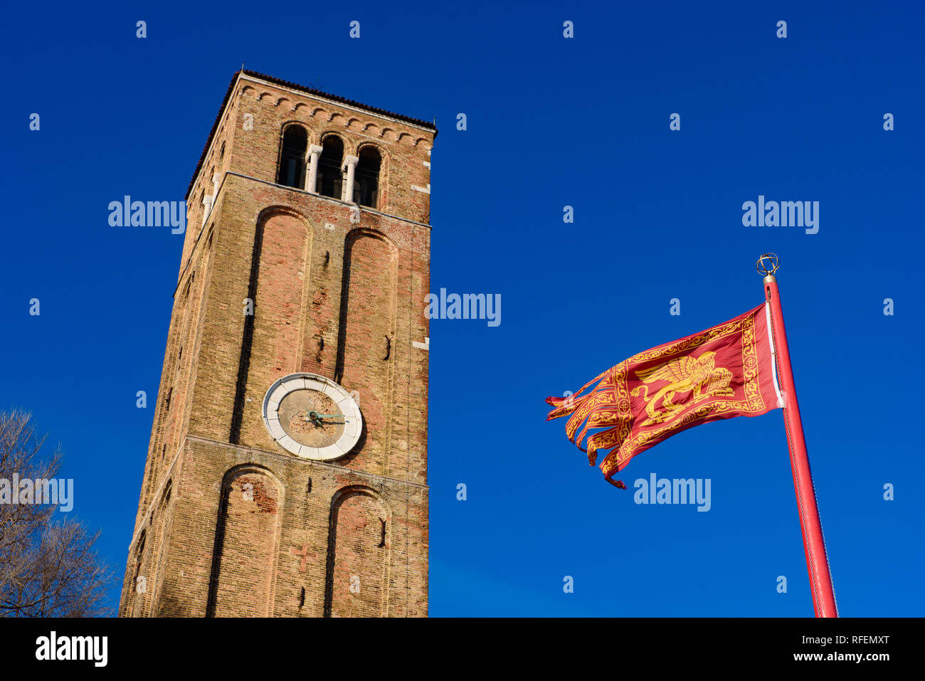 Clock tower and flag of Venice, Lion of Saint Mark Stock Photo