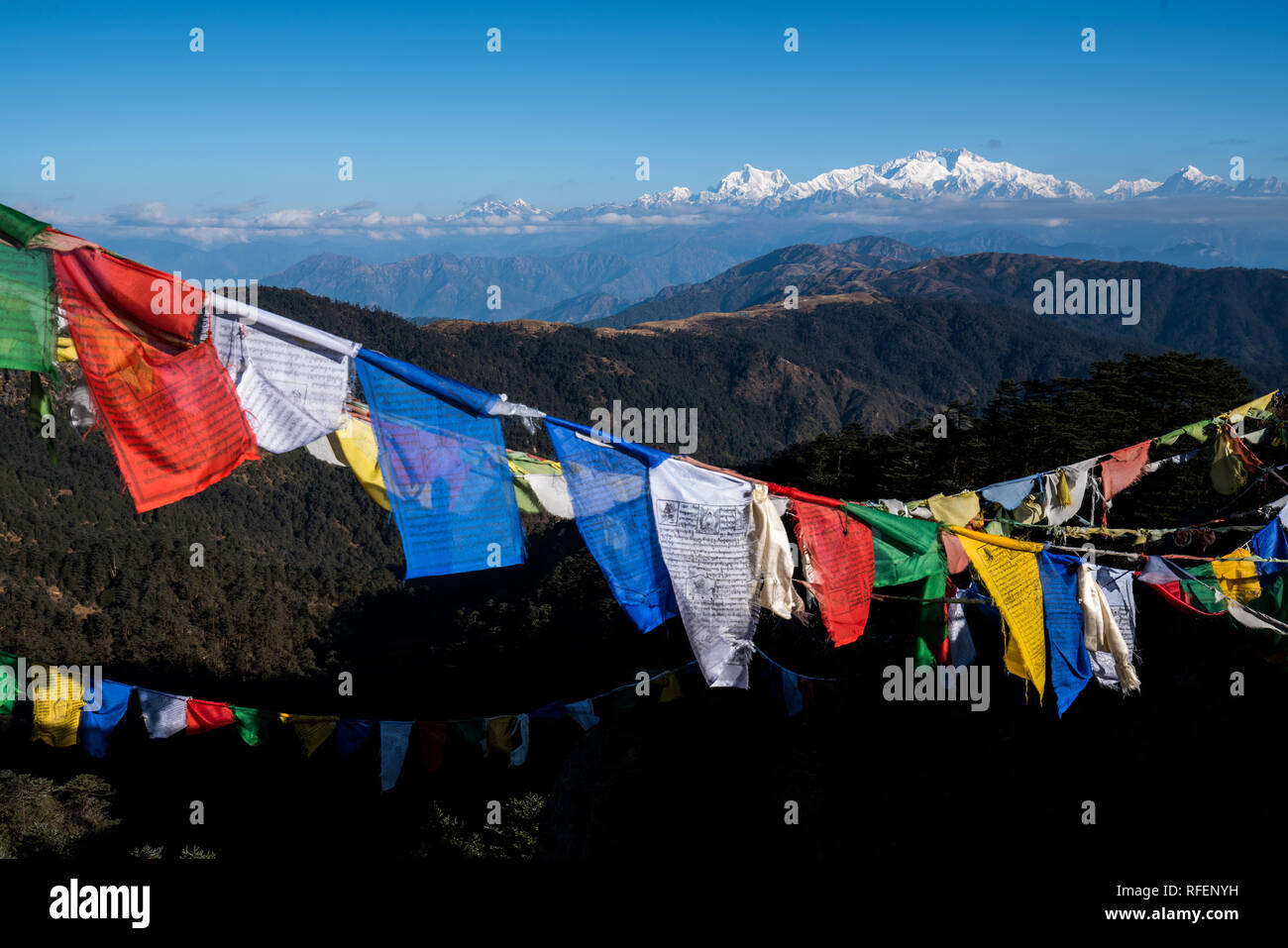 Tibetan prayer flag or Lung ta and Kangchenjunga high mountain range view from the Sandakphu , Darjeeling,  India Stock Photo