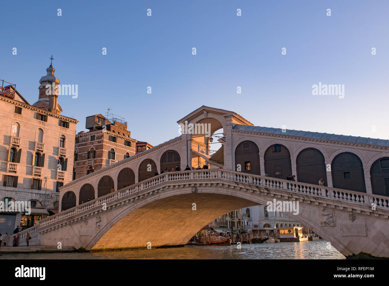 Rialto Bridge (Ponte de Rialto) across Grand Canal at sunrise / sunset time, Venice, Italy Stock Photo