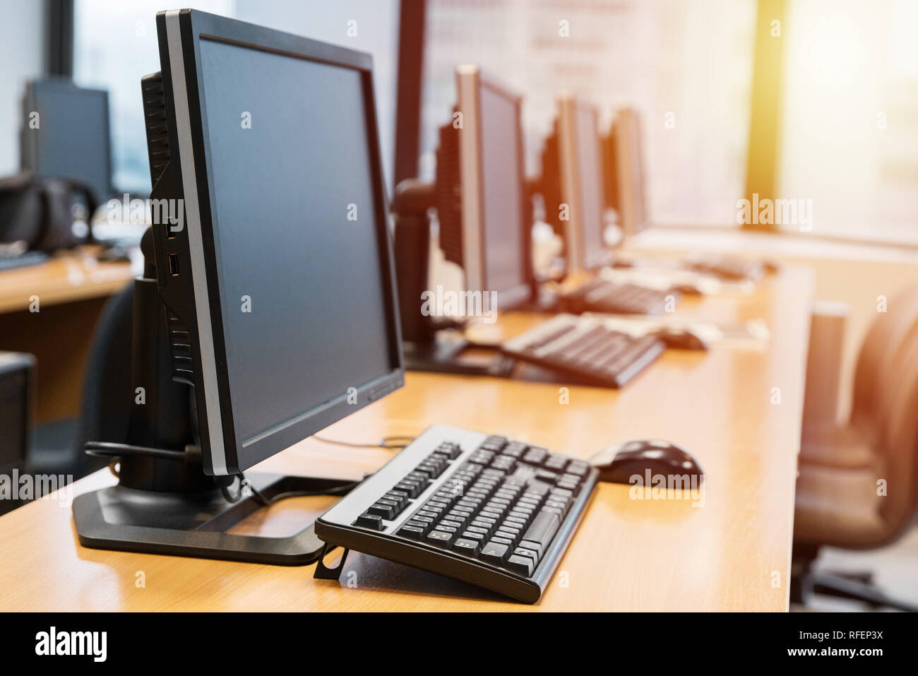 Empty computer room neatly placed for student in a computer lab. Stock Photo