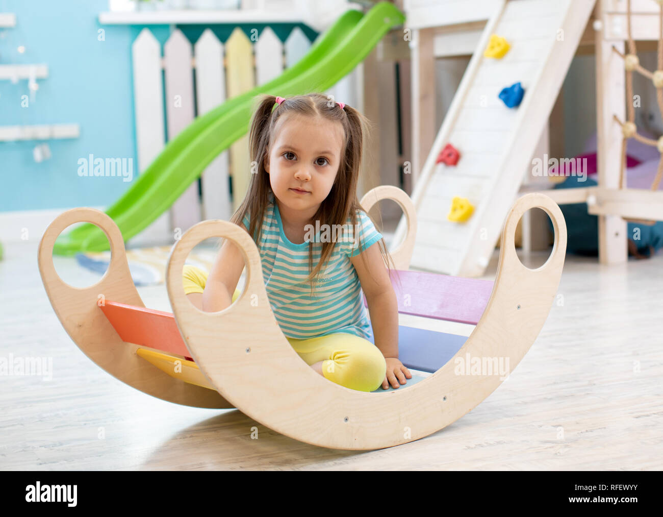 Cute child girl playing in nursery room Stock Photo