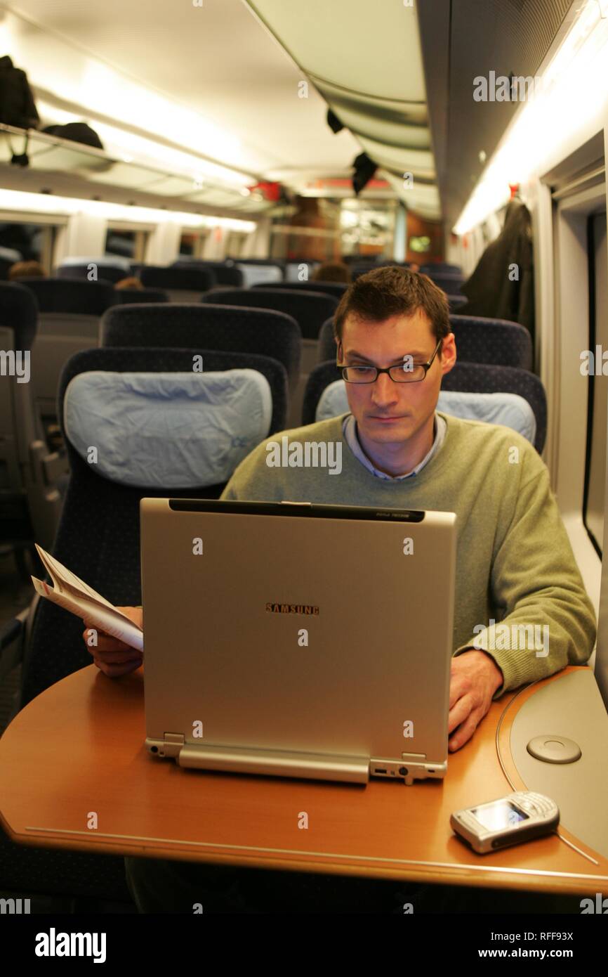 DEU Germany : Man works on his laptop computer on an ICE train. | Stock Photo