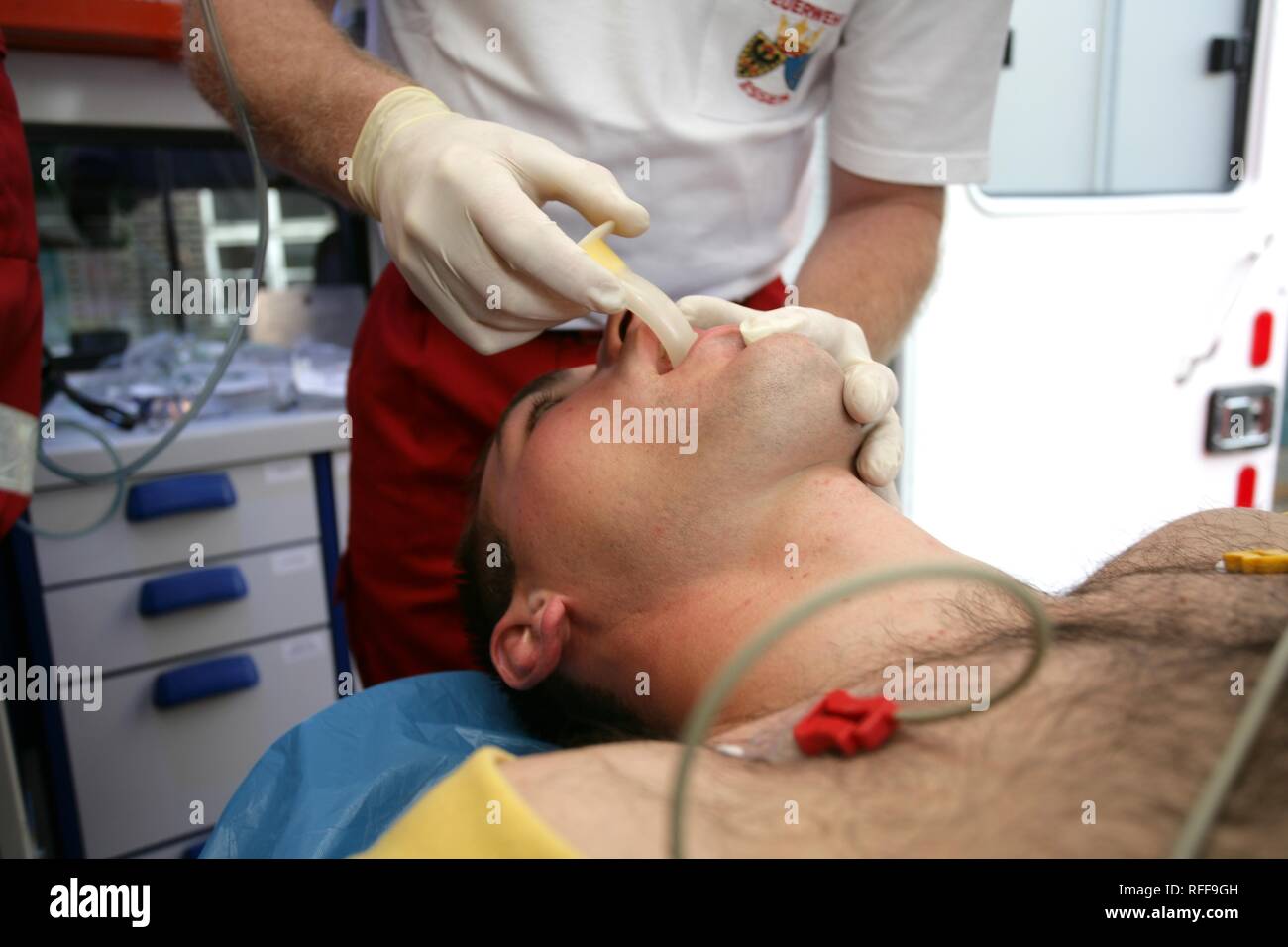 DEU Germany : Rescue paramedics in an ambulance truck attempt at resuscitation after a cardiac arrest. Training situation. | Stock Photo