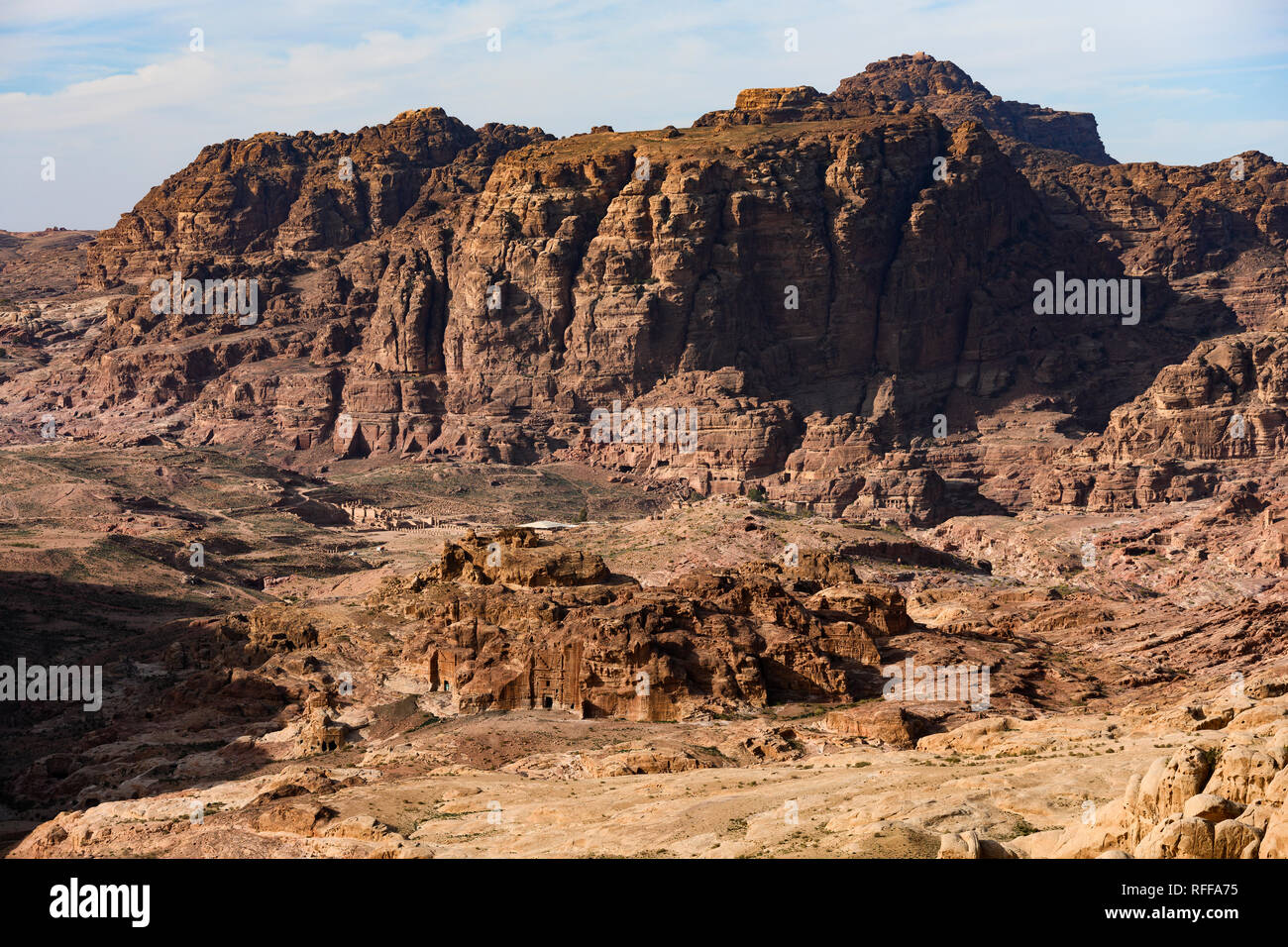 Amazing view of a beautiful canyon in Petra with the historical and archaeological city in distance. Stock Photo