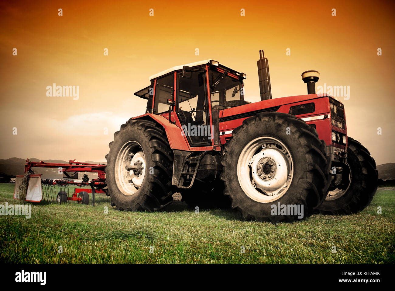 Old tractor on the grass field Stock Photo - Alamy