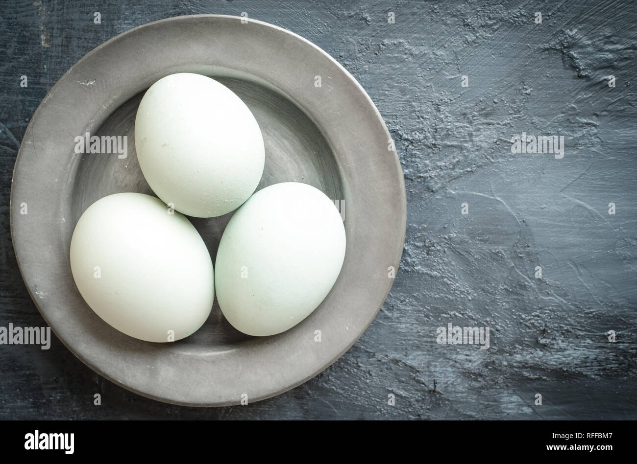 Eggs, eggshells on pewter plate Stock Photo