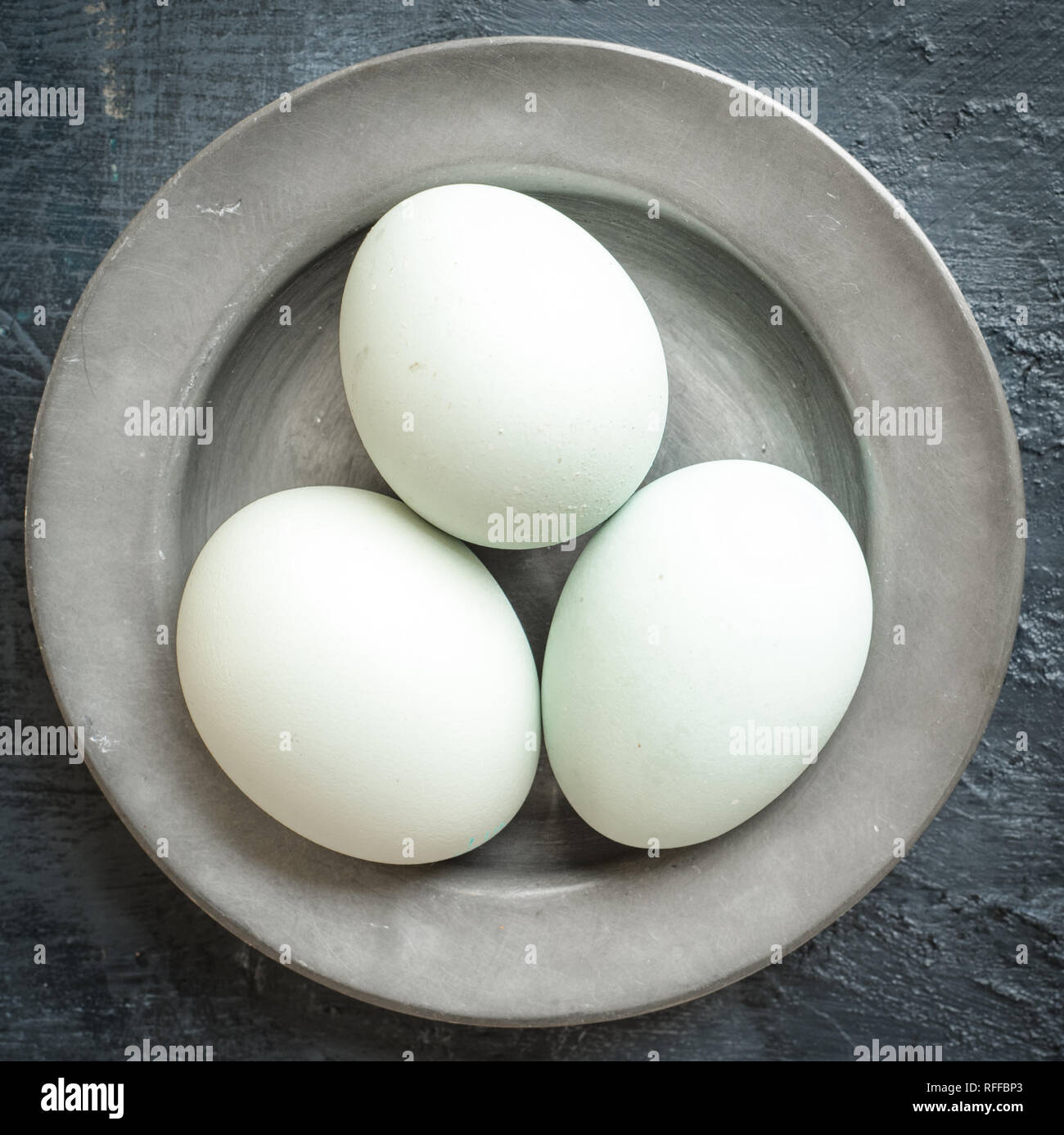 Eggs, eggshells on pewter plate Stock Photo