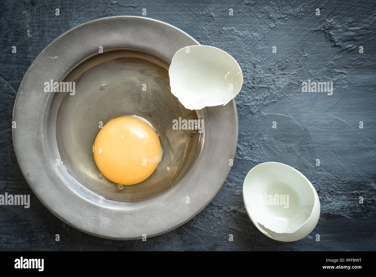 Eggs, eggshells on pewter plate Stock Photo
