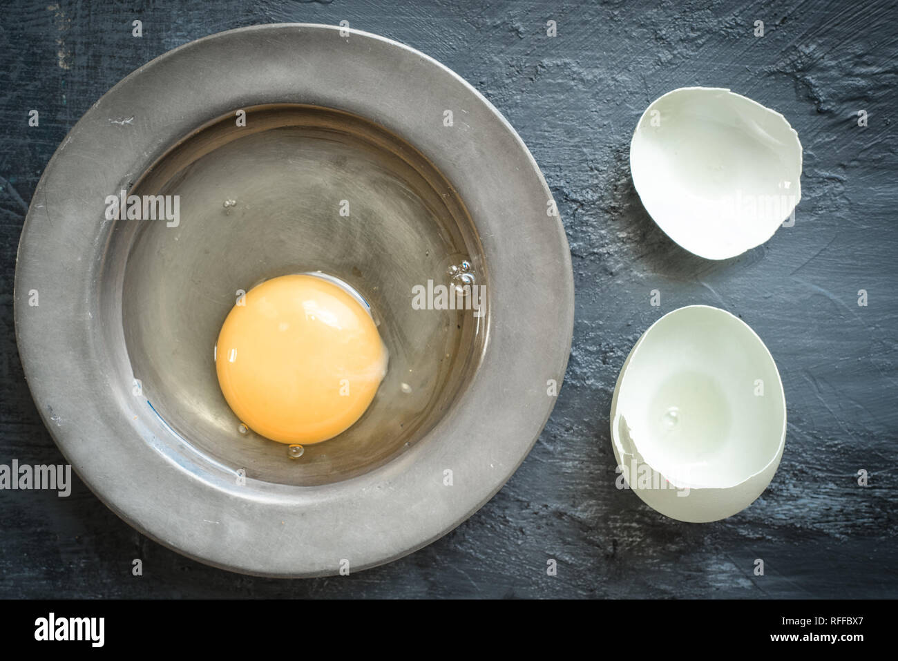 Eggs, eggshells on pewter plate Stock Photo