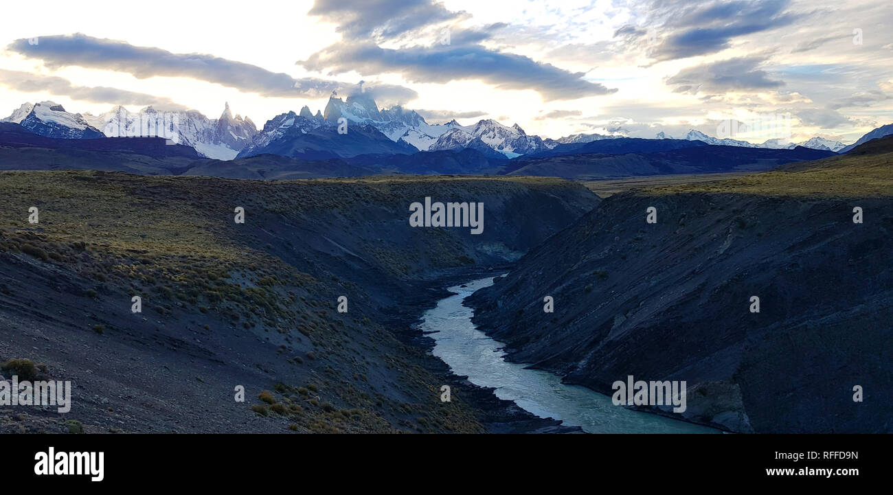View of Fitz Roy and Rio De Las Vueltas canyon near El Chalten, Patagonia, Argentina. The lights of the sunset on the peak of the Mount Fitzroy Stock Photo