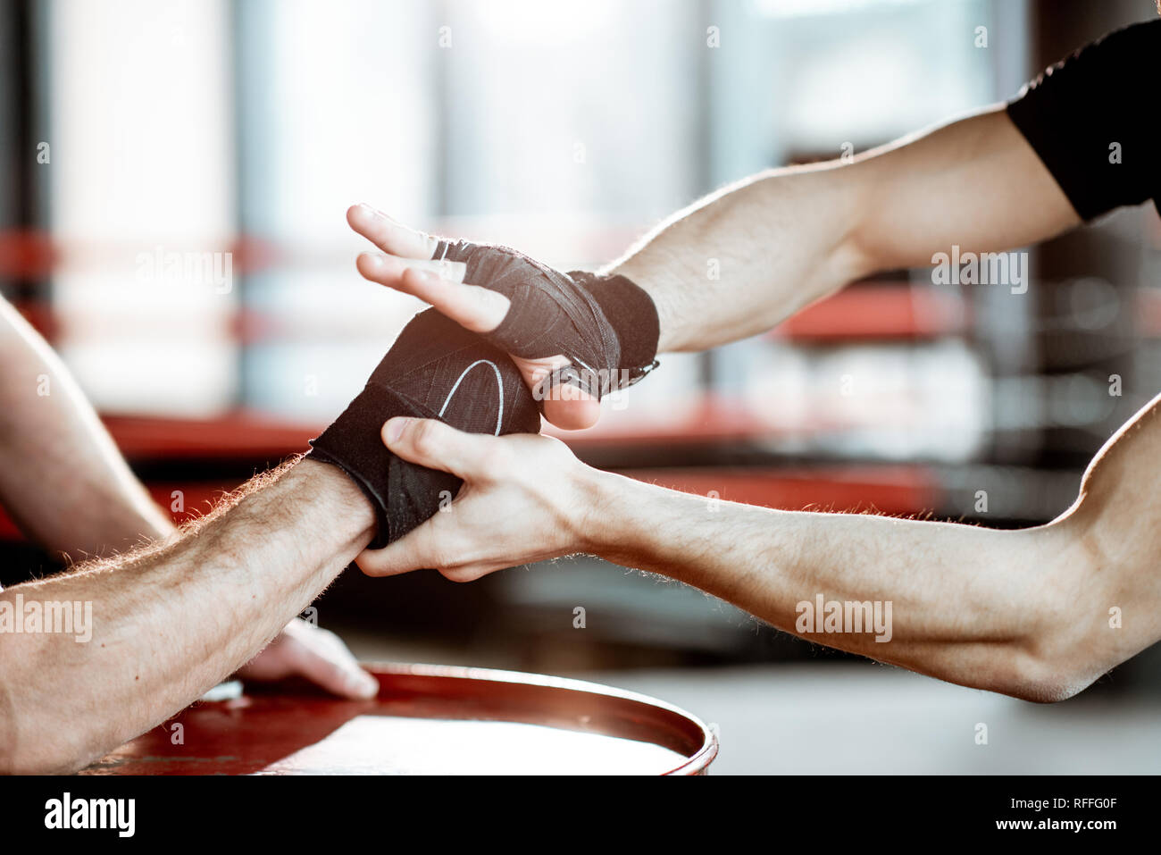 Close-up of a men's hands wrapped with boxing bandages in the gym Stock Photo