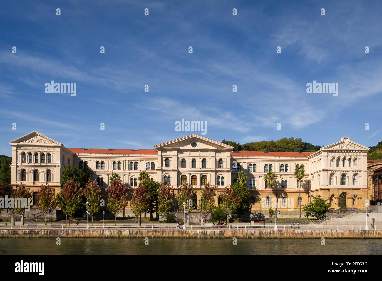 The building of the University of Deusto next to the river in  Bilbao on a sunny day, Spain Stock Photo