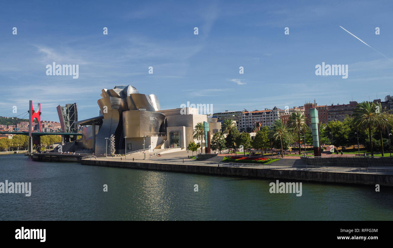 The Guggenheim Museum in Bilbao next to the river on a sunny day, Spain Stock Photo