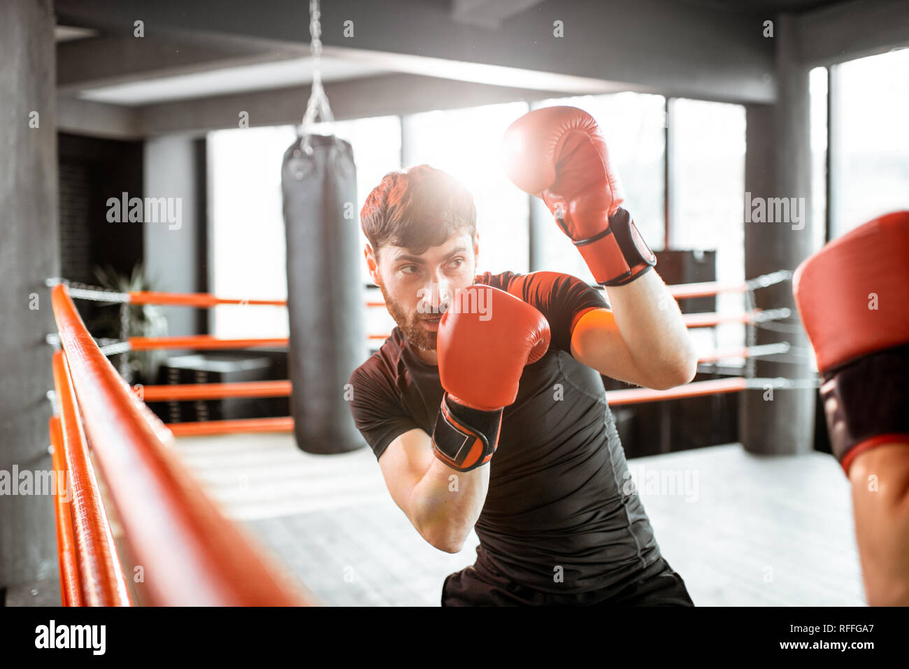 Two professional boxers in black sportswear during the fight on the