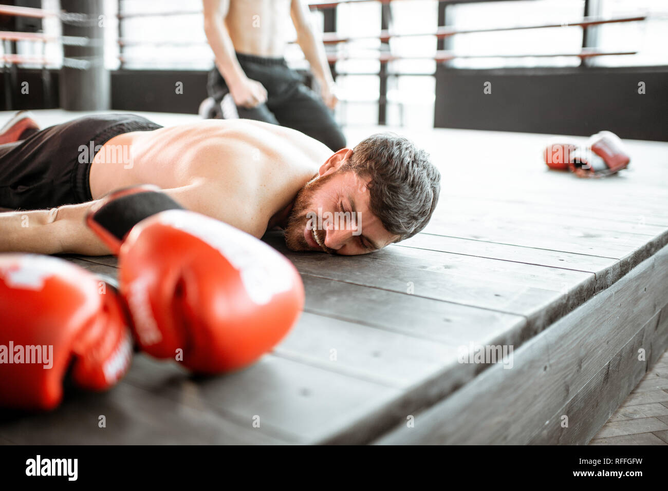 Pretty Female Boxer Knocked Out Laying On The Floor Stock Photo