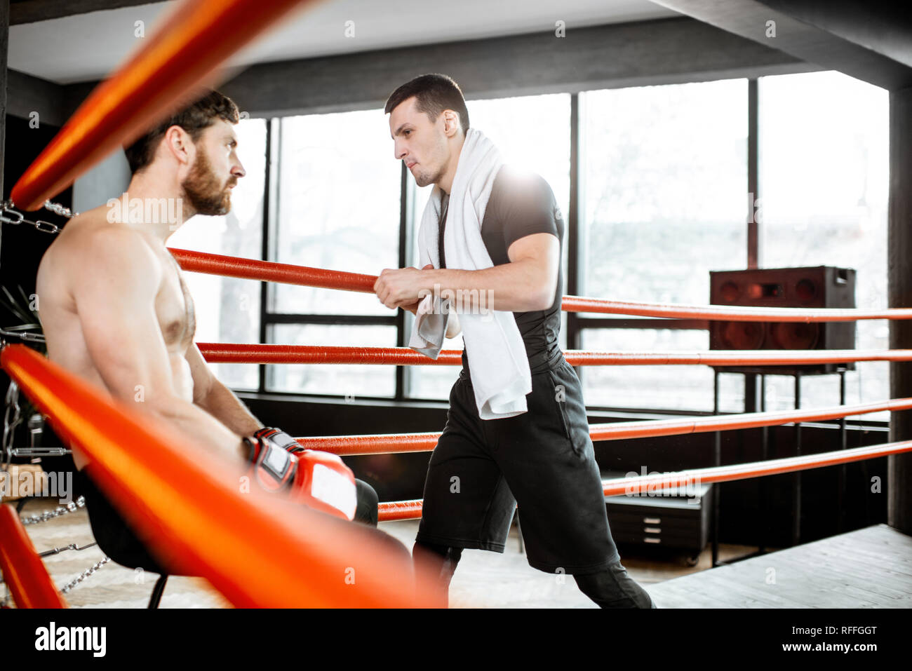 Boxing trainer giving instructions during a break motivating a boxer