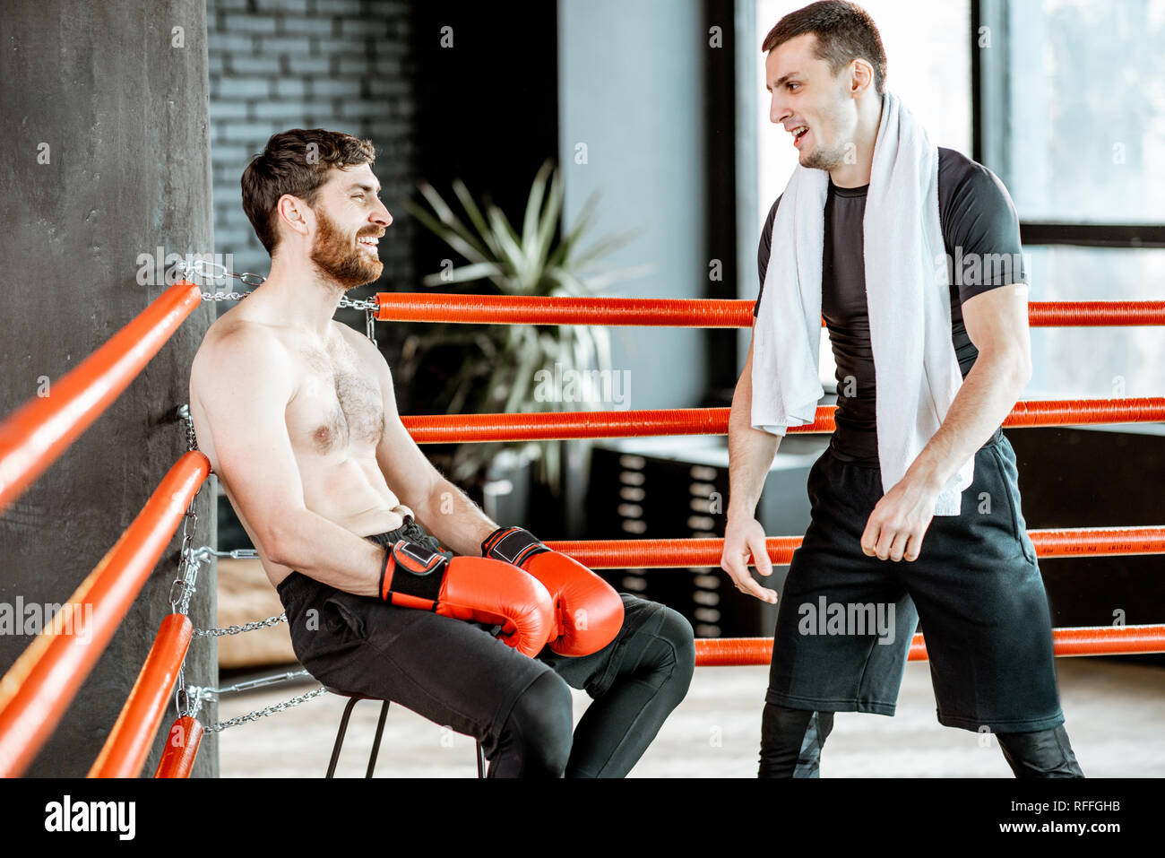 Boxing trainer giving instructions during a break motivating a boxer
